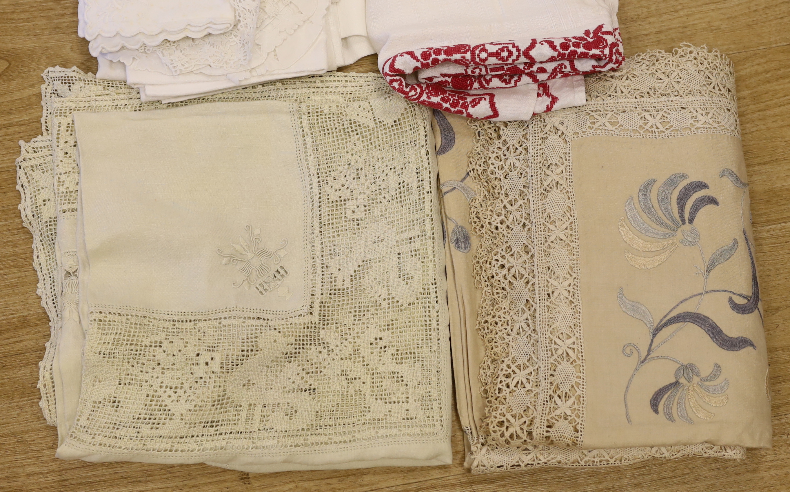 An Edwardian blue embroidered linen table cloth, an Italian embroidered and fillet insertion cloth and various mixed linens